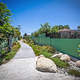 A “green street” in LA with permeable sidewalk materials, rain gardens, and special gutters that keep water local